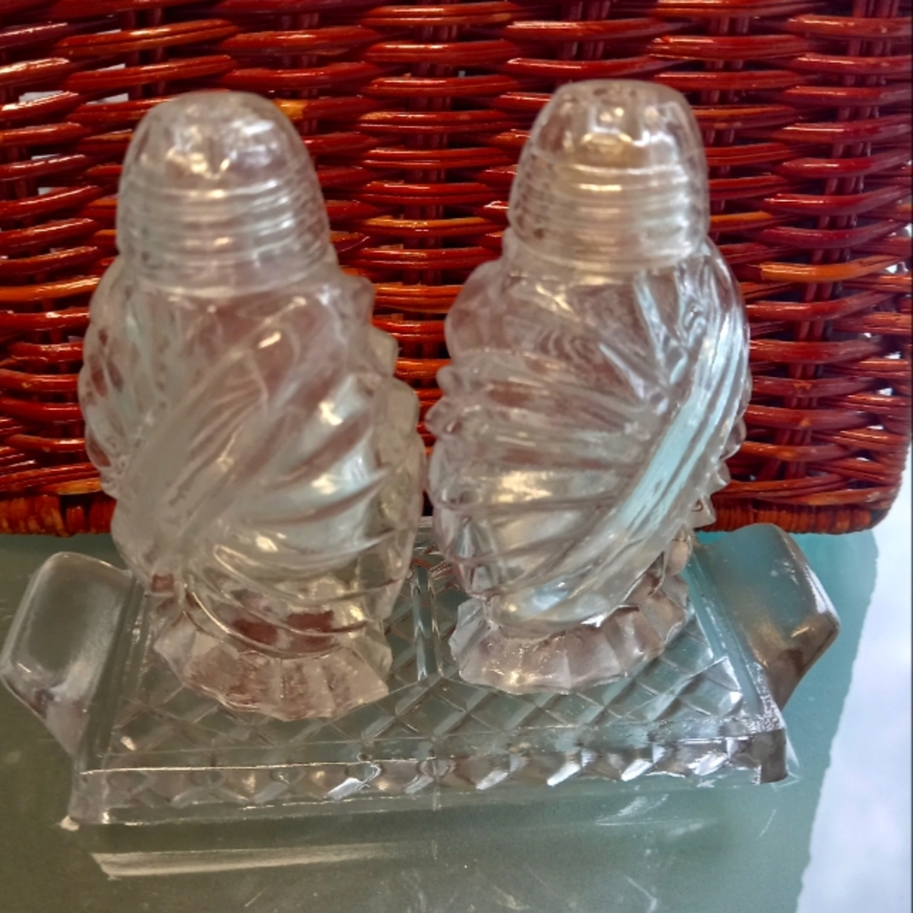 Vintage glass salt and pepper shakers with mini glass tray.